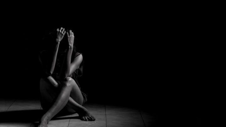 Depressed woman in dark room